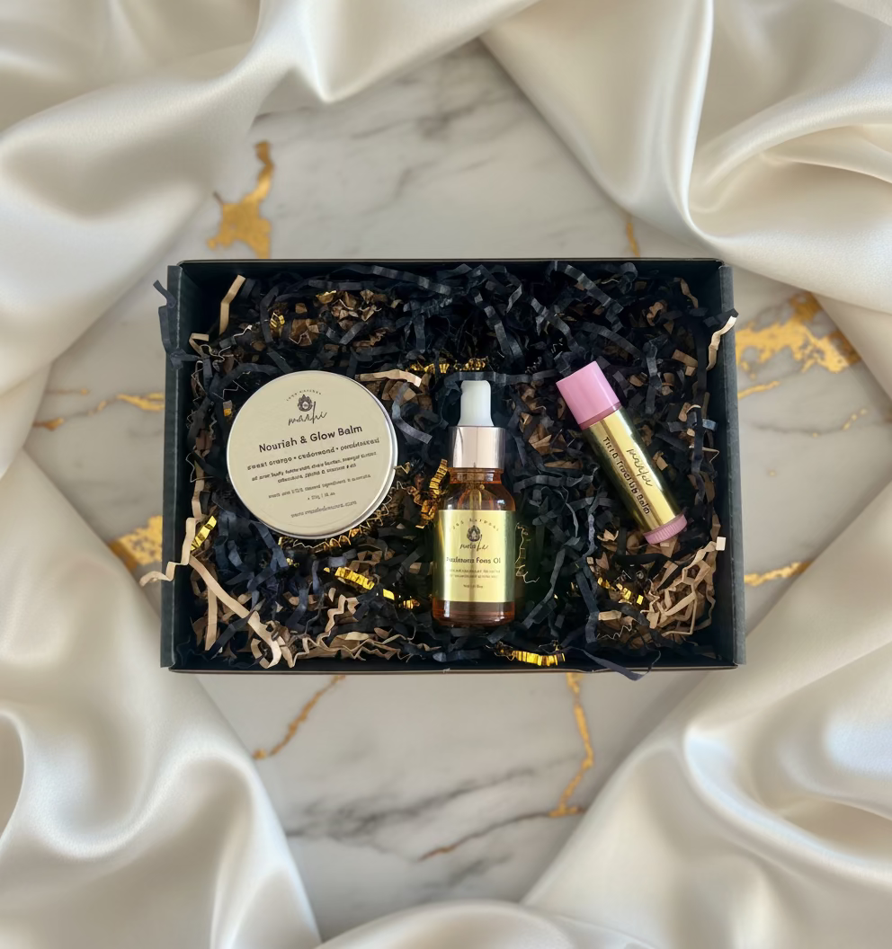 Skincare product set including balm, serum, and oil in a decorative box.